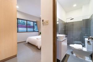 a bathroom with a bed and a toilet and a sink at 5BR Home - BBQ - City Centre - Free Pick Up for 3 nights in Ho Chi Minh City +33 photos