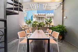 a table and chairs on a balcony with plants at 5BR Home - BBQ - City Centre - Free Pick Up for 3 nights in Ho Chi Minh City