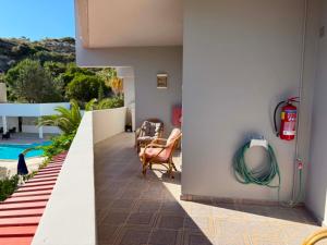 a balcony with a pool and a fire hydrant at Peter's Place Studios & Suites in Faliraki