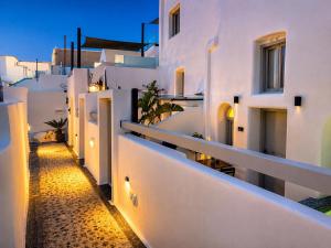 a view of a white building with a pathway at Tiara Suites Fira - Cycladic & Cave in Fira