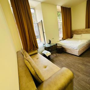 a living room with a couch and a bed at Mini hotel in centre in Yerevan
