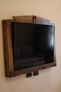 a flat screen tv hanging on a wall at Mugull Agrotourism Hotel in Tirana