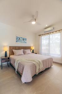a bedroom with a large bed and a window at Villa Ticalma in Parrita +35 photos