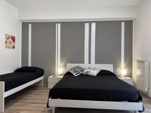 a bedroom with two beds and two lamps in it at EDEL Vacation Home in Terni