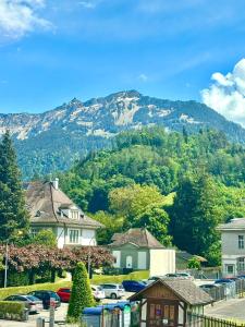 a mountain in the distance with cars parked at Heyko Holiday Interlaken in Interlaken