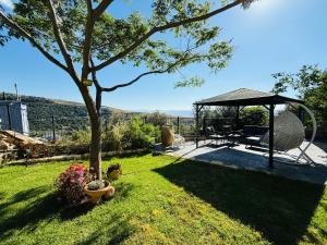 a garden with a gazebo and a picnic table at The Sky Zimmer in Ein Kinya