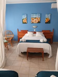 a bedroom with a bed with a blue wall at Portal 17 Can Tort in Tossa de Mar