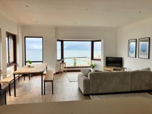 a living room with a couch and a table at The Lookout - Spacious 2 bed overlooking Kalk Bay in Kalk Bay