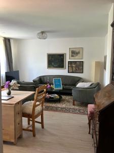 a living room with a couch and a table at Ferienwohnung Daun in Daun +5 photos