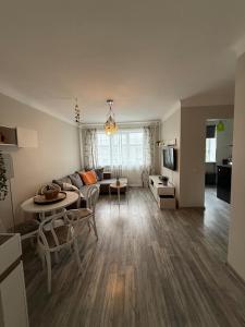 a living room with a couch and a table at Gallo Riga Apartments in Riga