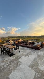 a patio with tables and chairs on a roof at Balloon Street Cappadocia in Göreme
