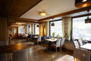 a restaurant with tables and chairs and a window at Hotel Bischof in Schmallenberg