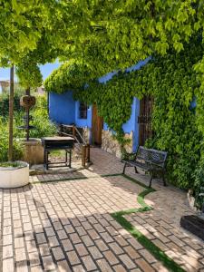 a bench sitting in front of a blue building at El Quinto Pino Riópar in Riópar