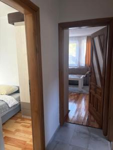 an open door to a room with a bedroom at DM Apartman in Foča