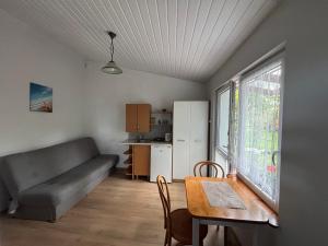 a living room with a table and a couch at Przy morzu in Jarosławiec