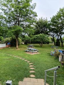 a picnic table and benches in a park at Bungalow tonga in Moncetz-lʼAbbaye