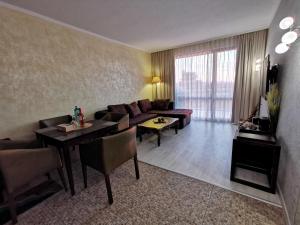 a living room with a couch and a table at Royal Beach Premium Residence- Sunny Beach in Sunny Beach