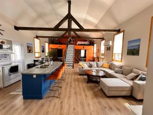 a kitchen and living room with a couch and a table at A Stay Across The Bay in Curling