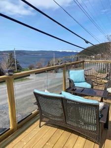 a balcony with a table and chairs on a deck at A Stay Across The Bay in Curling