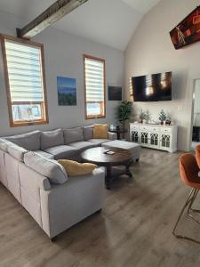 a living room with a couch and a table at A Stay Across The Bay in Curling
