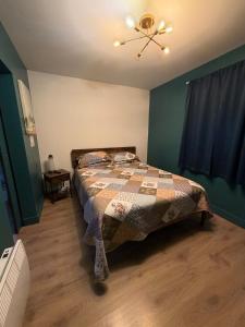 a bedroom with a bed and a ceiling fan at A Stay Across The Bay in Curling