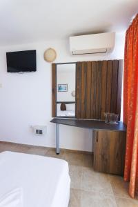 a room with a mirror and a desk at Hotel Arsenal in Nesebar