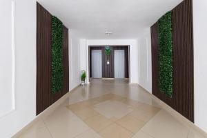 a hallway with green plants on the walls at Hotel Arsenal in Nesebar +113 photos