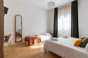 a hotel room with two beds and a mirror at Casa Orlando in Modena