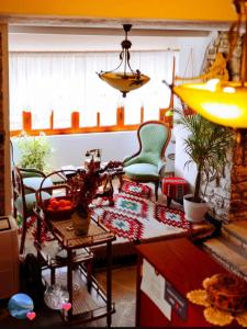 a living room with two chairs and a table at Guest House J.Prifti in Berat