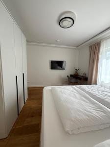 a bedroom with a white bed and a window at Hygge in Neumünster +3 photos