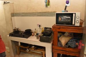 a microwave sitting on top of a kitchen counter at Bamboo Garden B&B in Kendwa