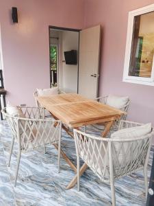 a wooden table and chairs in a room at Elevated Bungalow House 3-11 in Nathon Bay