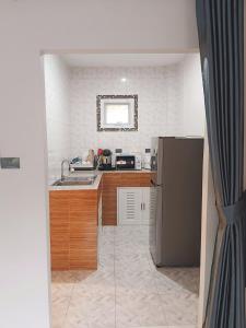 a kitchen with a sink and a refrigerator at Elevated Bungalow House 3-11 in Nathon Bay
