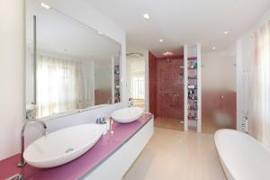 a bathroom with two sinks and a large mirror at Luxury Beachfront Villa Smague with Sauna, Zadar in Diklo +25 photos