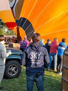 a group of people standing around a hot air balloon at Sky Ballonvaarten & Accommodaties in Tilburg