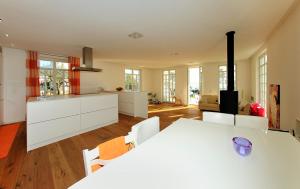 a kitchen with a white table and white cabinets at Luxury Beachfront Villa Smague with Sauna, Zadar in Diklo