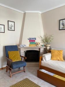 a living room with a couch and a chair at Brisa do Mar in Vagos