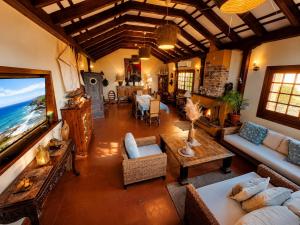 a living room filled with furniture and a large window at Fort Tenerife Gran Casa de Campo in Tacoronte