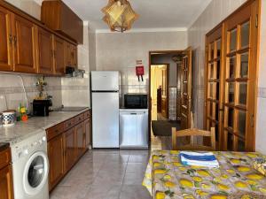 a kitchen with a refrigerator and a dishwasher at Brisa do Mar in Vagos +10 photos