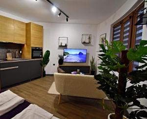 a living room with a couch and a flat screen tv at Oblivion in Velingrad +8 photos