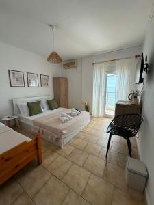 a living room with a bed and a couch at Seaside Stay Makrygialos in Makrygialos