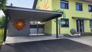 a garage with a painting on the side of a house at Apartment Karin in Langenwang