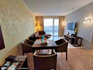 a living room with a couch and a table at Royal Beach Premium Residence- Sunny Beach in Sunny Beach