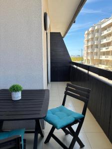 a balcony with a table and a chair on a balcony at Brisa do Mar in Vagos