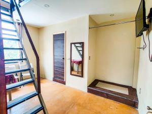 a room with a staircase and a mirror at Casa Argentina in San Juan La Laguna