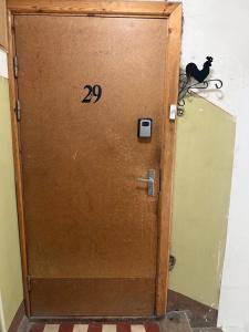 a wooden door with the number on it at Gallo Riga Apartments in Riga