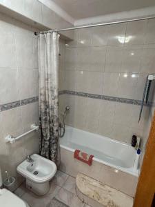 a bathroom with a tub and a toilet and a sink at Brisa do Mar in Vagos