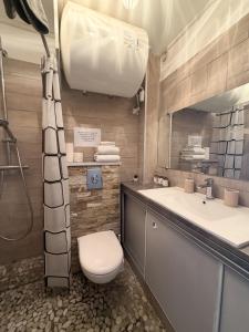 a bathroom with a toilet and a sink at Studio cosy climatisé vue sur port in Cap d'Agde