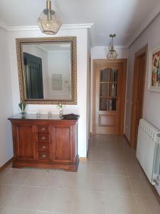 a bathroom with a mirror and a wooden dresser at Casa Río Tera in Garray