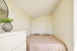 a small bedroom with a bed in a room at Sea View cottage with 2 sleeping cabins in Uddevalla